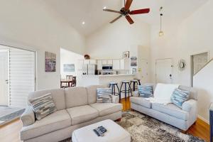 a living room with a couch and a ceiling fan at Shoreline Haven in Kimberling City