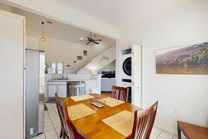 a kitchen and dining room with a wooden table and chairs at Shoreline Haven in Kimberling City