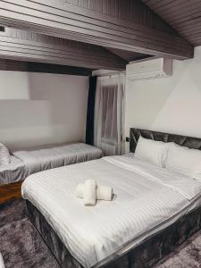 a bedroom with a large bed with two towels on it at Pushkin Hotel Yerevan in Yerevan