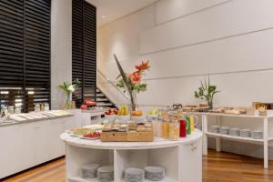 a large kitchen with a table with food on it at NH Córdoba Panorama in Córdoba