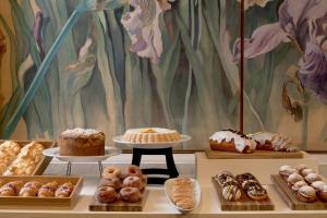 a display of different types of donuts and pastries at NH Córdoba Panorama in Córdoba