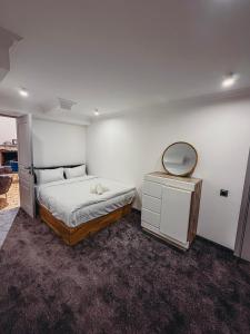a bedroom with a bed with a mirror and a dresser at Pushkin Hotel Yerevan in Yerevan +38 photos