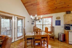 a dining room with a wooden table and chairs at Lost Creek Haven in Branson West