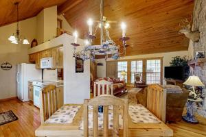 a kitchen and living room with a table and a dining room at Lost Creek Haven in Branson West +34 photos