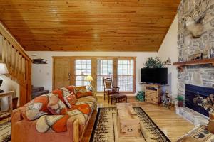 a living room with a couch and a fireplace at Lost Creek Haven in Branson West