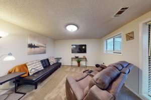 a living room with a couch and a table at Escape to Notch Estates in Branson West