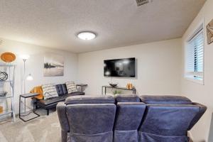 a living room with a couch and a tv at Escape to Notch Estates in Branson West
