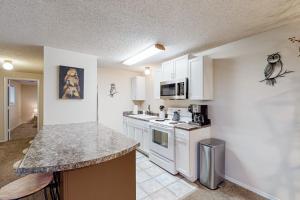 a kitchen with white cabinets and a counter top at Escape to Notch Estates in Branson West