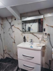a bathroom with a sink and a mirror at Pushkin Hotel Yerevan in Yerevan