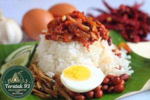 a plate of food with rice and an egg on it at Teratak 93 in Karak
