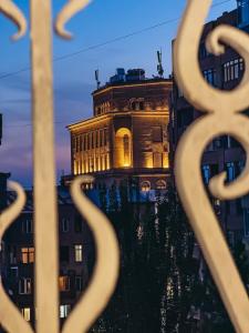 a building is seen through a chain link fence at Pushkin Hotel Yerevan in Yerevan