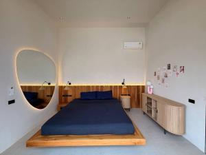 a bedroom with a large bed and a round mirror at MoonLight Villa - 3BR Tropical Pool Retreat in Ko Phangan +52 photos