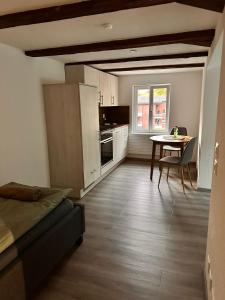 a kitchen with a table and a couch in a room at Haus Alpenhof in Wassen +5 photos