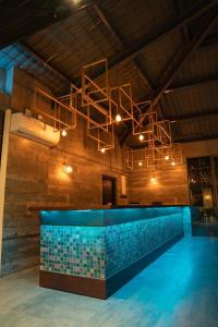 a lobby with a pool and a chandelier at Ankola Hotel in Homagama
