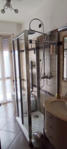 a bathroom with a shower and a sink and a mirror at La Casetta di Mari in Legnano
