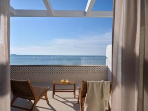 a room with a balcony with a view of the ocean at Shellona Rooms & Apartments in Laganas +35 photos