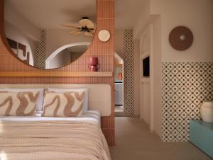 a bedroom with a large mirror above a bed at Shellona Rooms & Apartments in Laganas