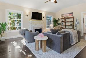 a living room with two couches and a fireplace at Coastal Charm in Santa Cruz