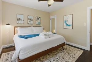 a bedroom with a large bed with towels on it at Coastal Charm in Santa Cruz +15 photos