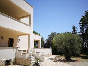 a white house with stairs on the side of it at Villa Ramolina - Metaponto in Metaponto