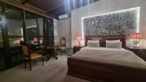 a bedroom with a bed and a desk and a piano at Grand Hotel 1902 in Baku