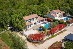 an aerial view of a house with a swimming pool at Villa Martha in Central Istria with private pool - wellness & table tennis for 12 persons in Žminj