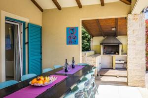a long table with a bowl of fruit on it at Villa Martha in Central Istria with private pool - wellness & table tennis for 12 persons in Žminj +42 photos