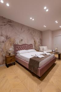 a large bedroom with a large bed and a wall mural at Palazzo Sospiri in Bisceglie