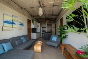a living room with couches and a table at Pacific Surfside Ocean Views in Surf City in ChiltiupÃ¡n