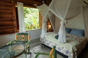 a bedroom with a bed and a chair and a window at Frana Lodge in El Zaino +105 photos