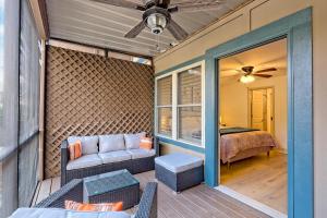 a screened in porch with a couch and a bed at Alpine Retreat in Helen
