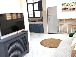 a living room with a large flat screen tv at The cosy corner in Zanzibar City
