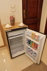 a refrigerator with its door open in a kitchen at Royal Town Hotel in Cairo