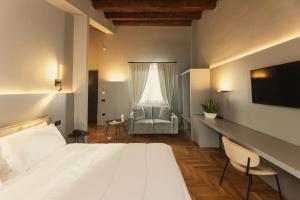 a bedroom with a large white bed and a chair at Masseria Pietrafitta in Foggia