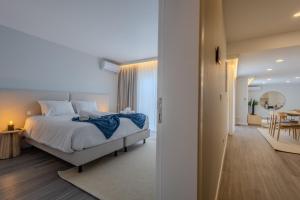 a bedroom with a bed and a dining room at Azor Signature Flats - I in Ponta Delgada