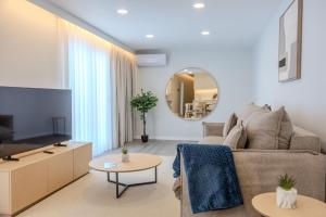a living room with a couch and a mirror at Azor Signature Flats - I in Ponta Delgada
