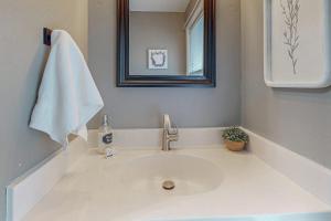 a bathroom with a sink with a towel and a mirror at The Loblolly in Bella Vista +16 photos
