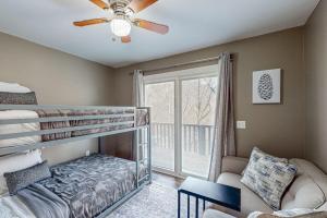a bedroom with a bunk bed and a couch at The Loblolly in Bella Vista