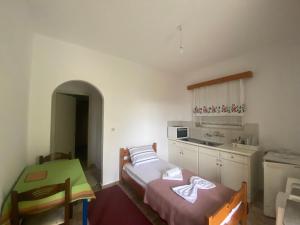 a small room with a bed and a kitchen at Apartments MOYRKOS in Missolonghi