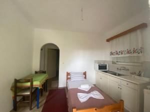 a small kitchen with a sink and a bed in a room at Apartments MOYRKOS in Missolonghi +13 photos