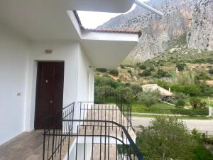 a staircase leading up to a house with a mountain at Apartments MOYRKOS in Missolonghi
