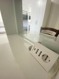 a white sink in a room with a mirror at Renaio House Buti in Bientina