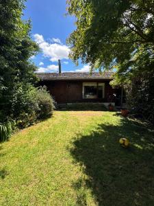 a house with a yard in front of it at Casa Amparo in Frutillar