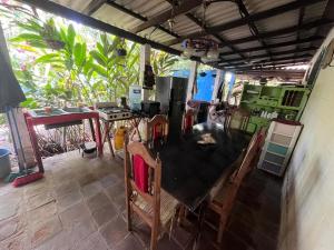 a kitchen with a table and chairs in a room at Punta Roca Surf House in El Majahual