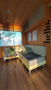 a room with a bed and a table and a couch at CHIC Riverfront Retreat with Private Jacuzzi, BIG BERRY in Gradac