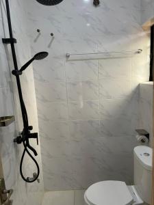 a bathroom with a shower with a toilet at Lloyd Hotel and Suites in Benin City