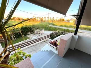 a view of a garden from a room with a window at Windmill view apartment in Antimácheia