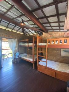 a room with three bunk beds in a house at Hostel do Ceu in Pipa +117 photos