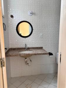 a bathroom with a sink and a mirror at Casa das Petúnias in Ubajara +8 photos