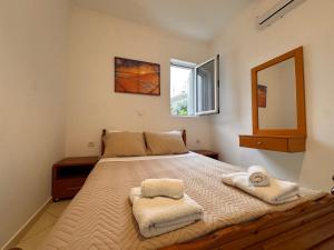 a bedroom with a large bed with towels on it at Spilea Apartments in Himare